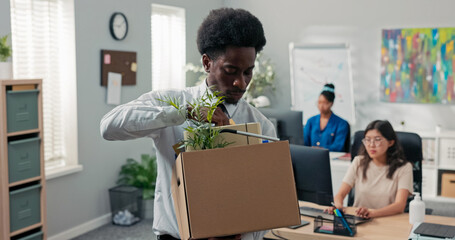 A man quits his corporate job, leaving the office with a packed box of belongings. He pauses at the...