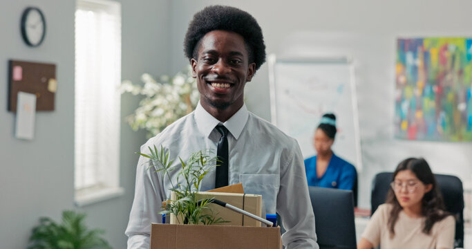 A man quits his corporate job, leaving the office with a packed box of belongings. He pauses at the door, checking to make sure he took everything, smiling happily as he retires.