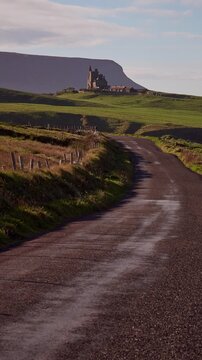 Classiebawn Castle with Benbulben mountain in the background on a scenic rural road, Sligo, Ireland