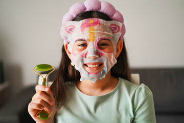 Female kid wearing skincare face mask - Cosmetic and children concept - Main focus on face