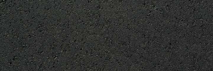New dark black asphalt background. Closeup. Wide banner. Empty place for text. Top down view.