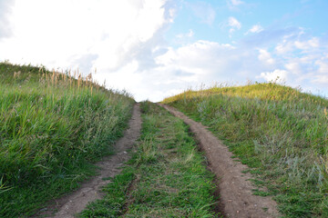 Uphill Dirt Track Through Green Fields