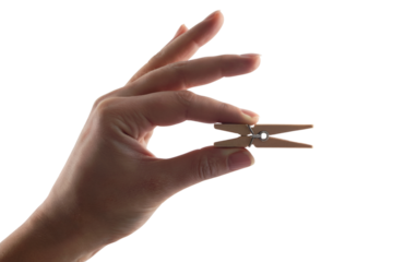 Hand holding clothespin. Isolated on transparent background, png