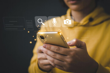 Person using mobile phone with search microphone camera icons for social media and communication apps