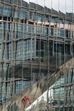 Layers of glass and steel merge into architectural reflections, showing the density and transparency that define contemporary urban structure