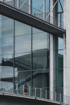 Contemporary facade with large reflective windows blending transparency, symmetry and depth, symbolizing the precision of modern urban architecture