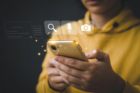 Person using mobile phone with search microphone camera icons for social media and communication apps