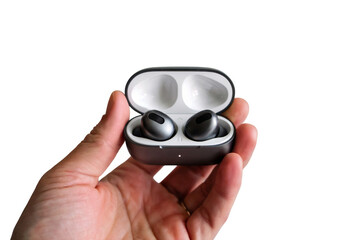 Fototapeta premium Wireless earbud in open case held by hand. Isolated on transparent background, png