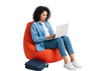 Serene Laptop Session: A focused young woman with curly hair is immersed in her work on a laptop, seated comfortably on a vibrant beanbag chair in a light and airy space. 