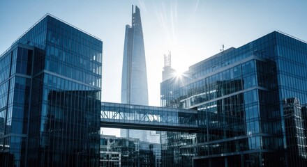 Sunburst over modern glass office buildings and a towering skyscraper in a city