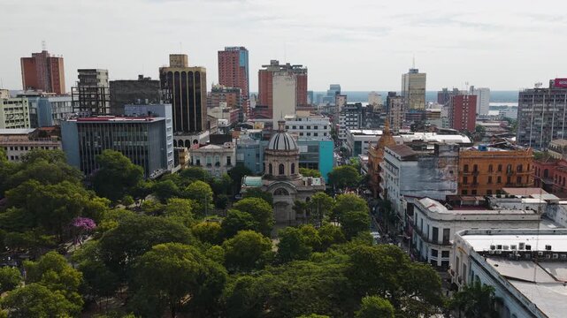 Pantheon of the National Heroes with domed roof surrounded by plazas and colonial buildings near central Asunci&oacute;n, Paraguay. Dolly in aerial.