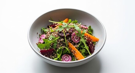 Vibrant quinoa, beet, carrot, and arugula salad in a white bowl, on a clean white surface