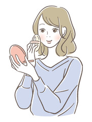 化粧をする笑顔の女性