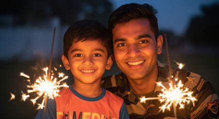 A proud father in an army uniform celebrates a festive evening outdoors with his young son, both holding sparklers