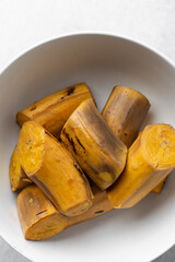 overhead view of peeled and unpeeled boiled ripe plantains © this_baker