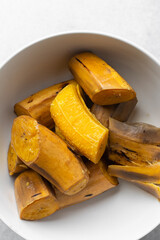 overhead view of peeled and unpeeled boiled ripe plantains © this_baker