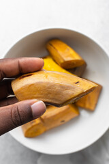 overhead view of Boiled ripe plantain in a white bowl, top view of nigerian cooked ripe plantain
