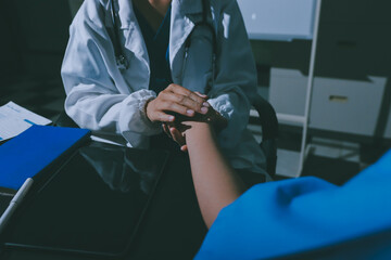 healthy concept; Doctor checking patient's heart with stethoscope at a hospital