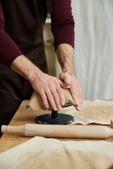 Young man skillfully shapes clay at a pottery studio during a creative session