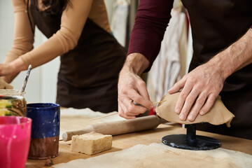 Young couple creates art together in pottery studio full of love and joy
