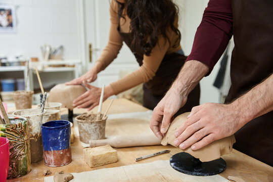 Loving couple creates beautiful pottery together in a cozy studio filled with creativity