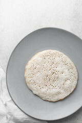 Overhead view of a plate of sinasir, top view of food from northern nigeria sinasir rice pancake