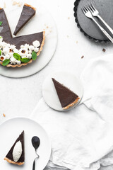 Overhead view of a slice of chocolate tart on a white plate, top view of no bake chocolate tart on a white background