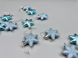 Blue Christmas star decorations scattered on a light surface, top view