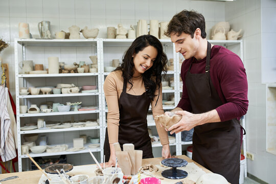 Loving couple shares creative moments at pottery studio crafting together - Powered by Adobe