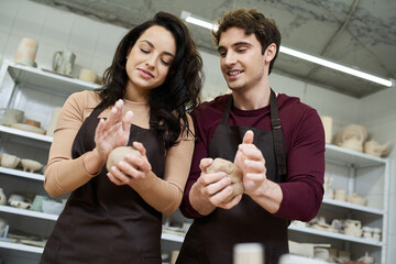 Joyful moments shared by a couple as they create pottery in a cozy studio setting