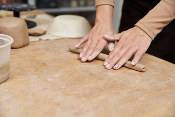 Exploring creativity in a pottery studio with a young woman shaping clay