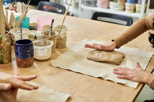 Joyful moments of creativity in a pottery studio with a young couple making memories