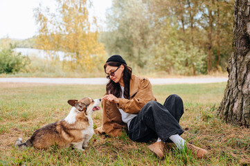Owner and their dog walking together outdoors, enjoying a walk and caring for the pet in nature.