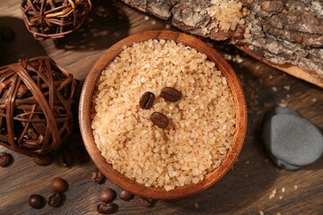 Natural sea salt and coffee beans on wooden table, flat lay
