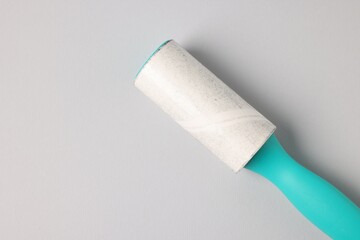 One lint roller on light grey background, top view. Space for text
