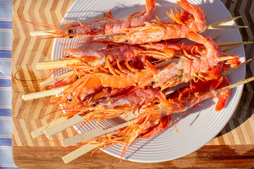 Grilled gambas skewers, oceanic feast for Lunar New Year, smoky umami celebration, culinary artistry shimmering under sunlit serenity