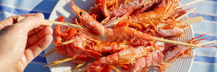 Grilled prawns glisten under the sun, invoking sun-soaked fiestas and coastal celebrations, perfect for National Seafood Month indulgence