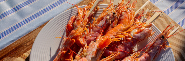 Sizzling jumbo prawns on skewers, evoking sunlit seafood fiestas, succulent crunch, World Oceans Day tribute, vibrant coastal feast