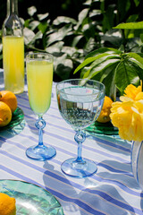 Lemon elixir and crystalline water glisten beside sunlit citrus, capturing Midsummers rustic charm and Litha's vibrant festivities