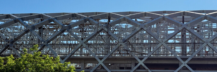 Steel girders weave a labyrinthine dreamscape, evoking Constructivist harmonies and Industrial...