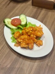 Crispy fried chicken coated in creamy salted egg sauce (ayam telur asin), a savory Indonesian-Chinese fusion dish with a rich, buttery flavor and golden coating. October 2, 2025 - Jakarta, Indonesia