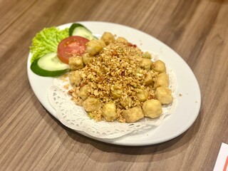 Crispy fried tofu with chili and salt (tahu cabe garam), a spicy Indonesian-Chinese dish known for its crunchy texture and bold, savory flavor, October 2, 2025 - Jakarta, Indonesia