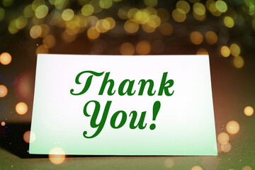 Thank you card design with bokeh lights on colorful background