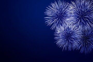 Fototapeta premium Vibrant blue fireworks exploding with white streaks on midnight blue sky background