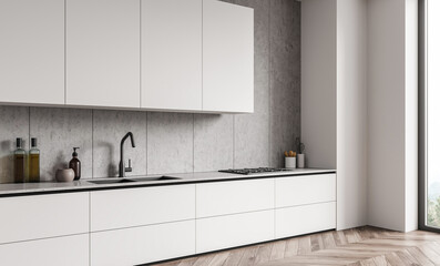 Sleek white kitchen interior with minimalist cabinets, concrete wall panels, and wooden herringbone...