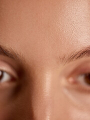 Obraz premium Close-up of smooth forehead and clear skin showing natural texture. Concept of skincare, health, and radiation for beauty, dermatology, and cosmetic advertising.