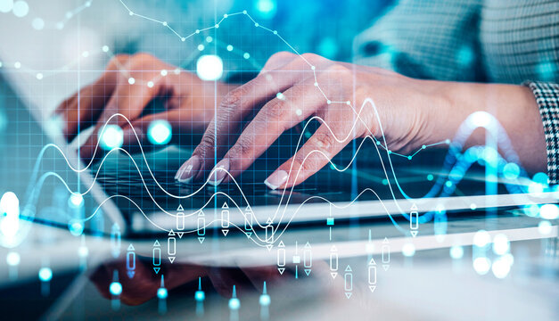 Close-up of hands typing on laptop keyboard with abstract financial graphs overlay, modern blue background, concept of digital finance and technology - Powered by Adobe