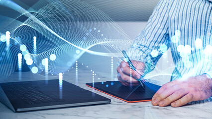 Man using stylus on tablet near laptop, glowing abstract wave and dot pattern overlay, on marble desk background. Concept of digital creative process