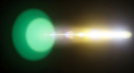 Abstract light flare with a green orb and a bright yellow streak, creating a dynamic and ethereal visual effect on dark background