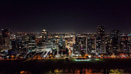 Drone night shot of Perth central business district skyline with tall skyscrapers and glowing lights © jovannig